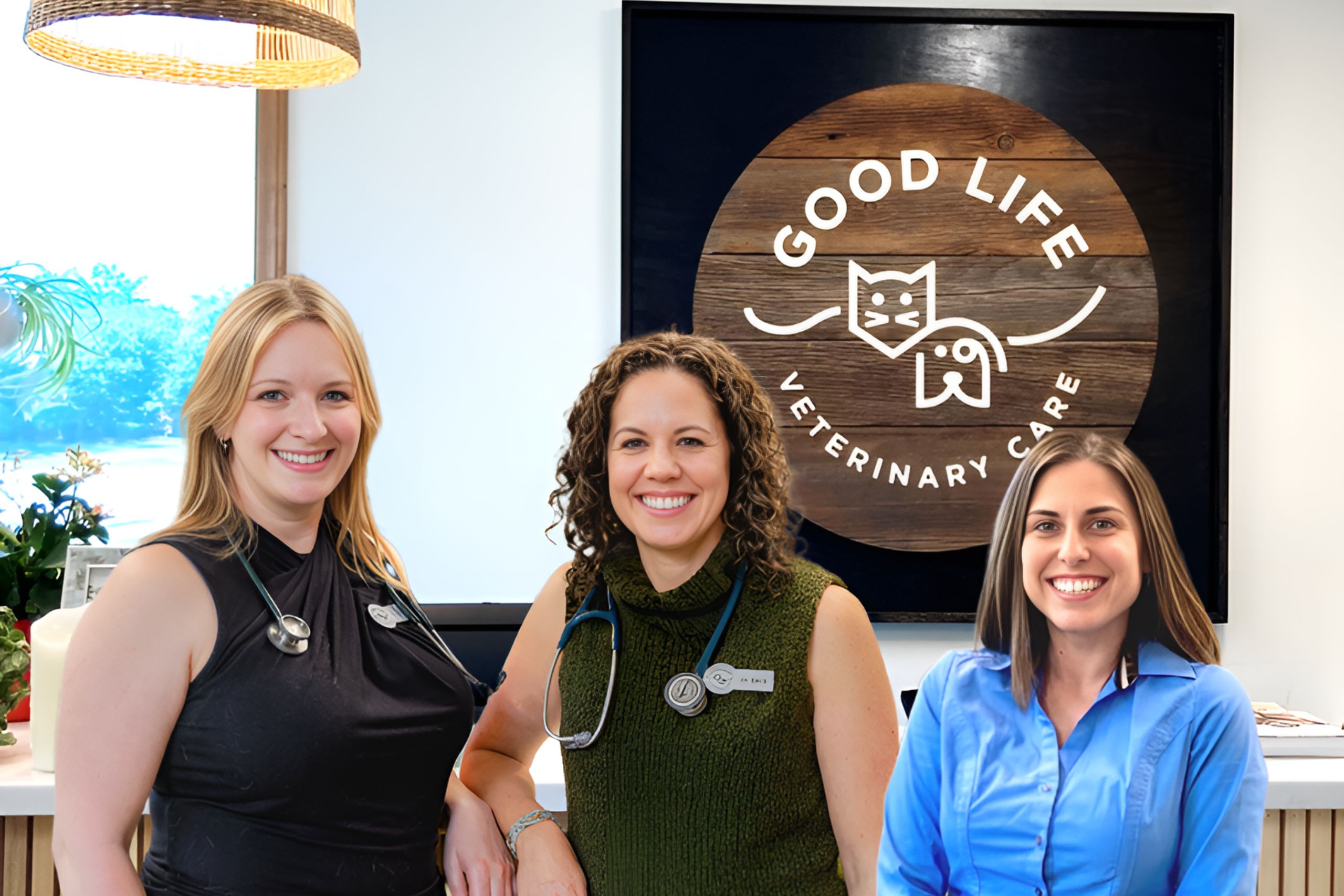 three women standing in front of a sign